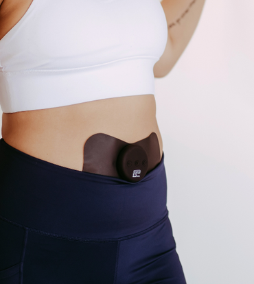 Relief Pro wearable TENS device on lower abdomen.