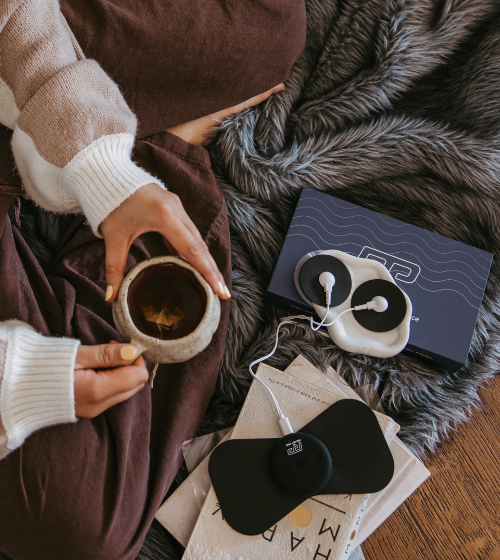 Relief Pro wearable TENS device on lower abdomen.